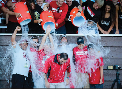 ICE BUCKET CHALLENGE: Varsity team captains and coaches participate in the ice bucket challenge at Meet the Bulldogs over the summer.