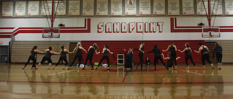 The dance team practices their prop dance at their early bird practice.