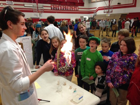 LPOSD elementary students react when Sandpoint High student Joel Crosby lights a dollar bill on fire at the Science Circuit.