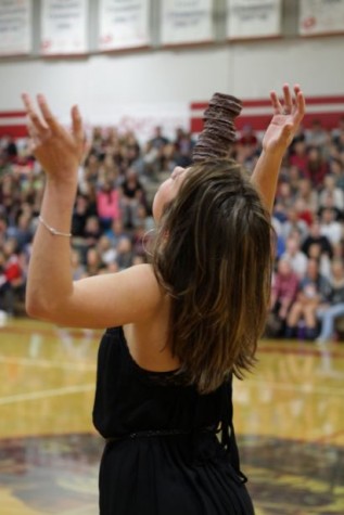 Senior Sara Gillmer participated in the assembly game which required students to balance cakes on their head as part of a relay team.
