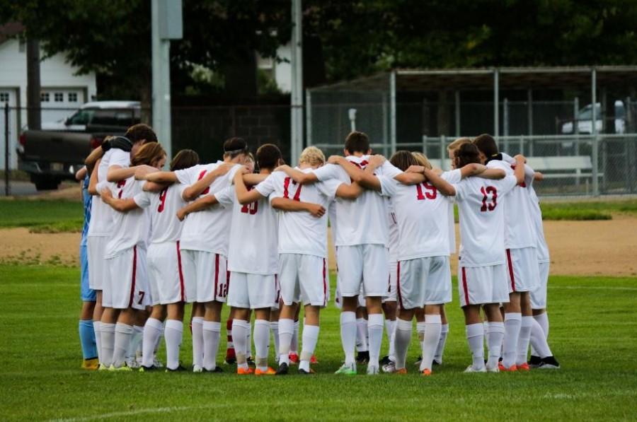 The boys varsity team meets before their game earlier this month on Sept. 1.