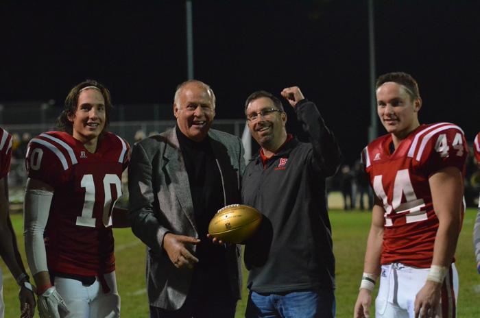 Kramer presents the Golden Ball to Athletic Director Kris Knowles.