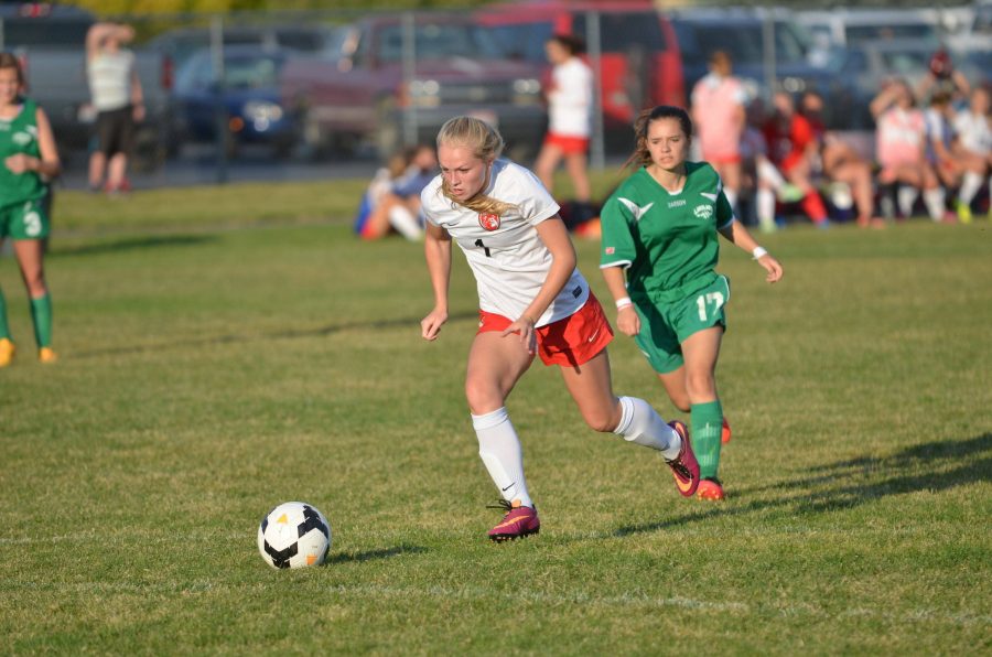 Junior Shelby Flathers  dribbles the ball towards the goal during the girls JV soccer match on Sept. 28. 