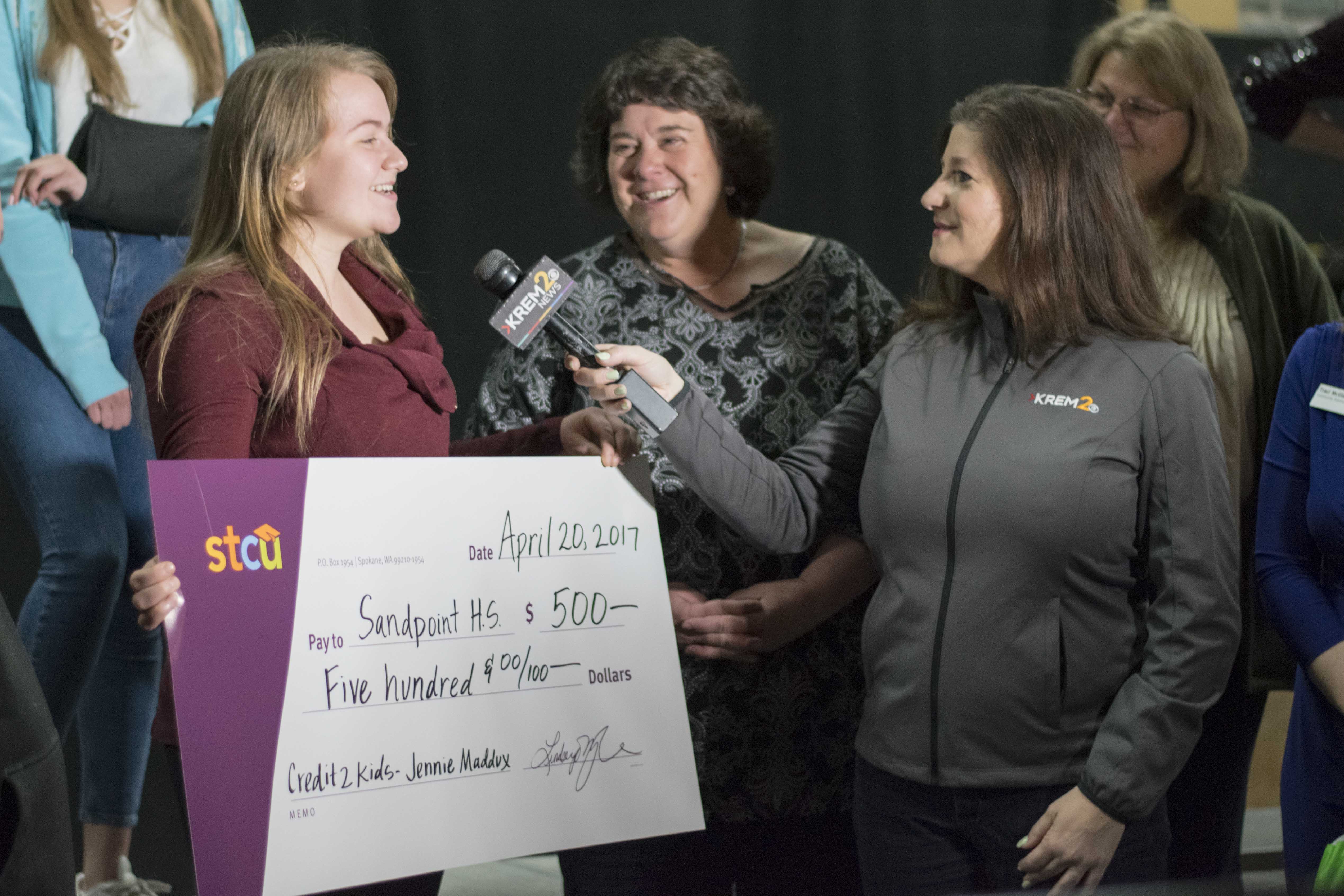 Junior Jennifer Maddux receives $500 from KREM 2 News and STCU while in her choir class. Maddux’s parents and school counselors Jeralyn Mire and Cindy Albertson were with the news team to present the check.
