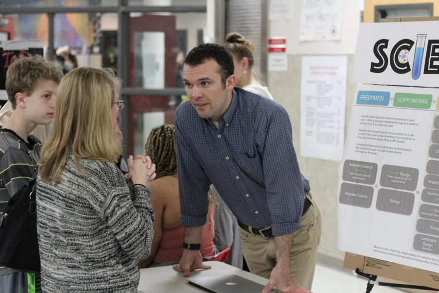 Science teacher Mike Martz discusses Sandpoint’s science program with an eighth grader’s parent. 