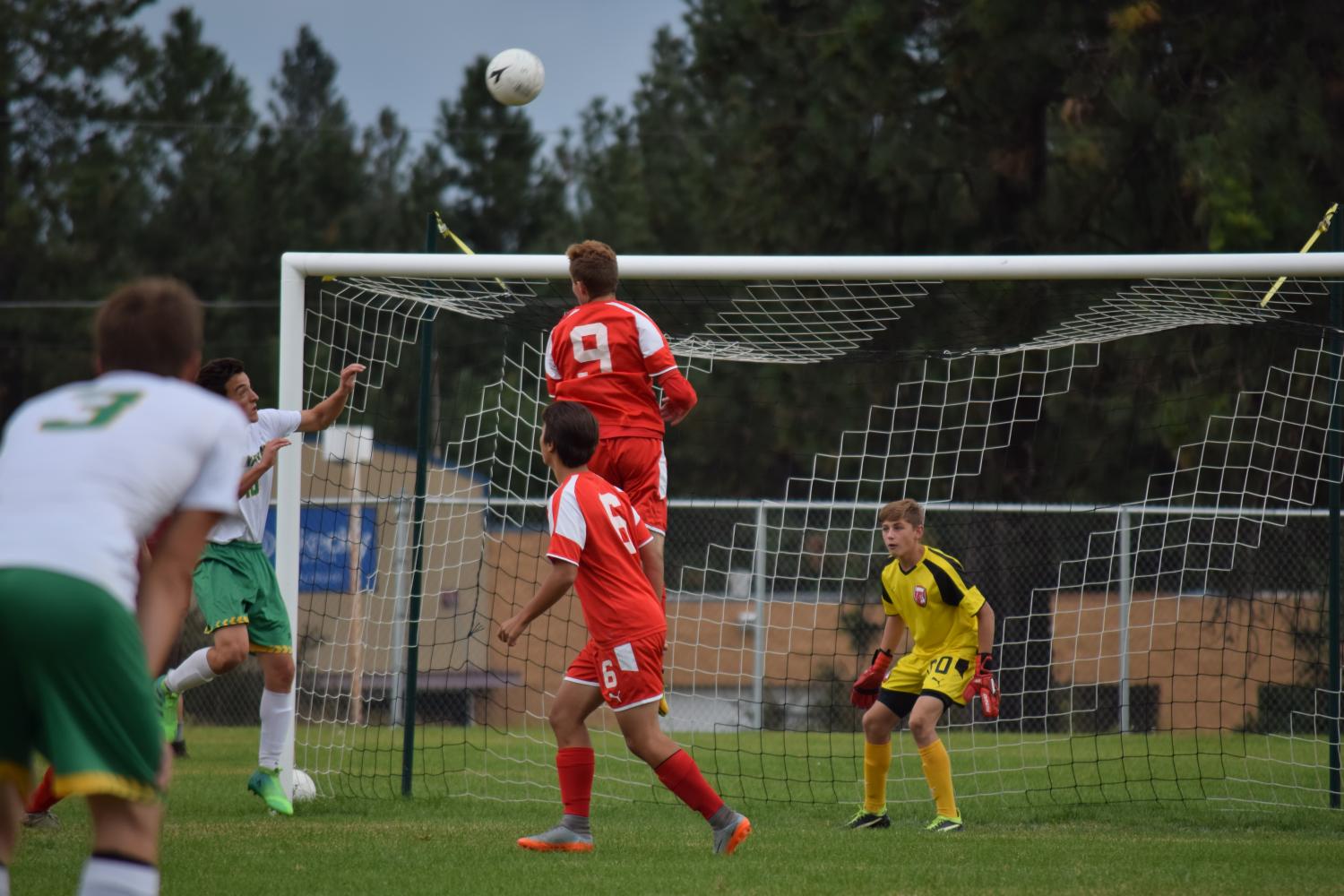 Senior Noah Hastings goes up for a header to protect the goal. 