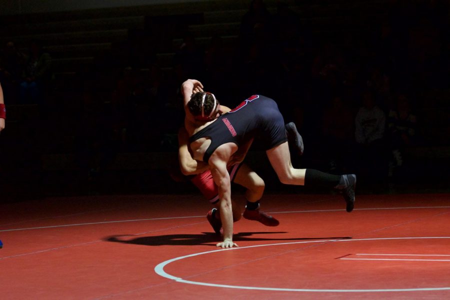 Sophomore Brady Nelson (red) and Senior Levi Sweeney wrestled at the 145 weight class on Wednesday’s red and white night.