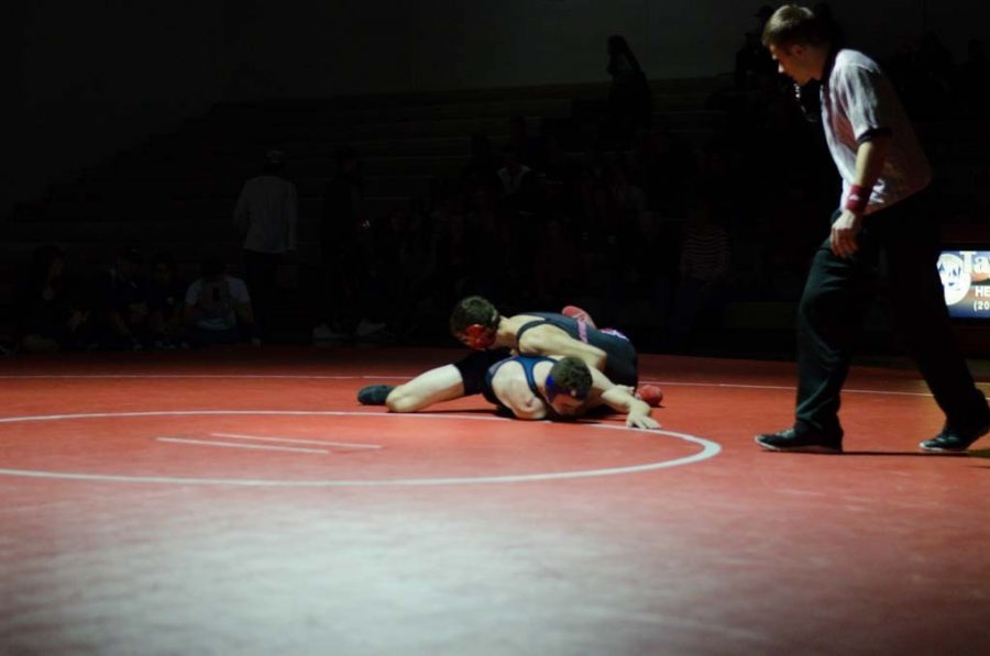 Sophomore Brady Nelsen makes a move on a Lake City wrestler.