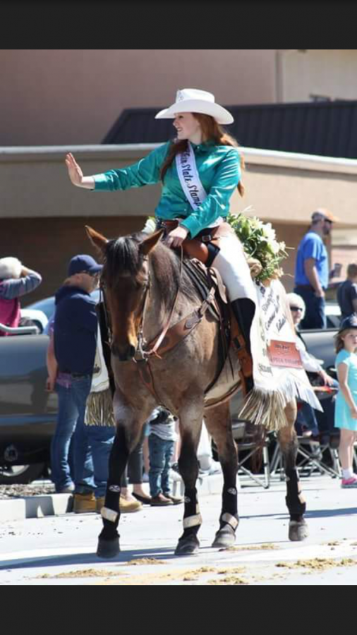 Senior Taylor Hill waves to an audience after winning Rodeo Queen. 