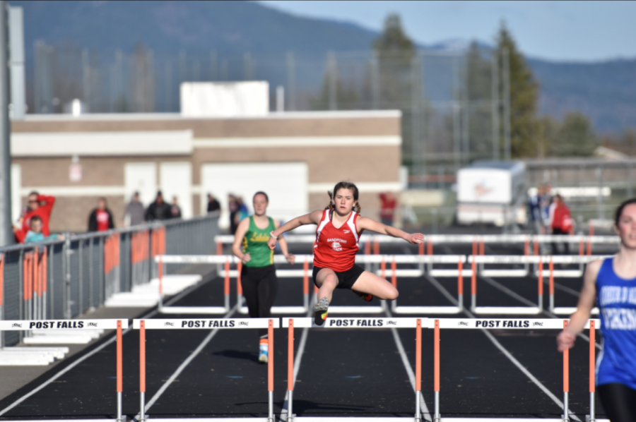 Sophomore Corina Wallace jumps over the last hurdle in the Women’s 300 Meter Hurdles. 