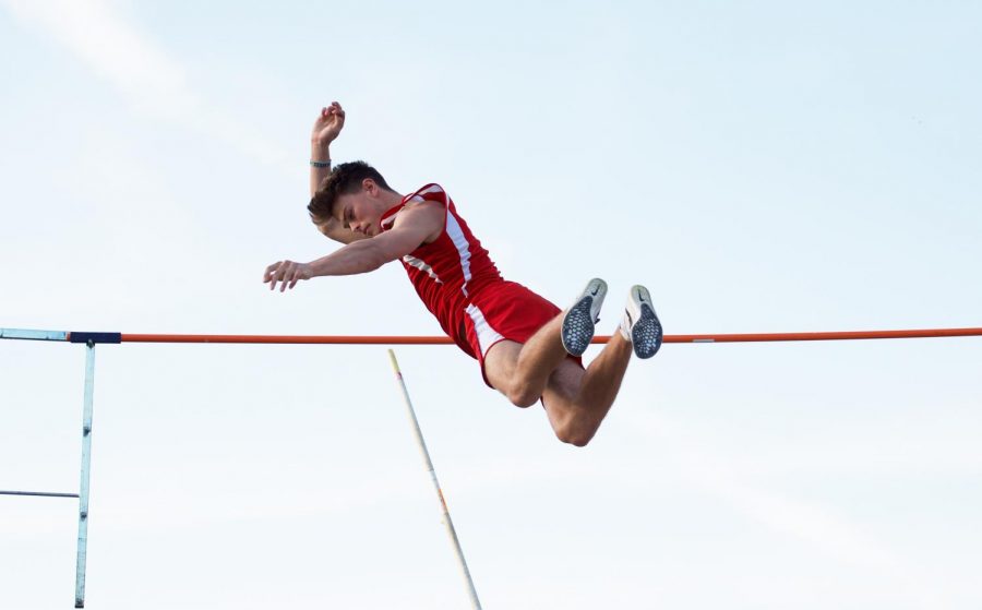 Senior Robbie Johnson clears a height in the men’s pole vault competition. Johnson placed third overall in the meet. 