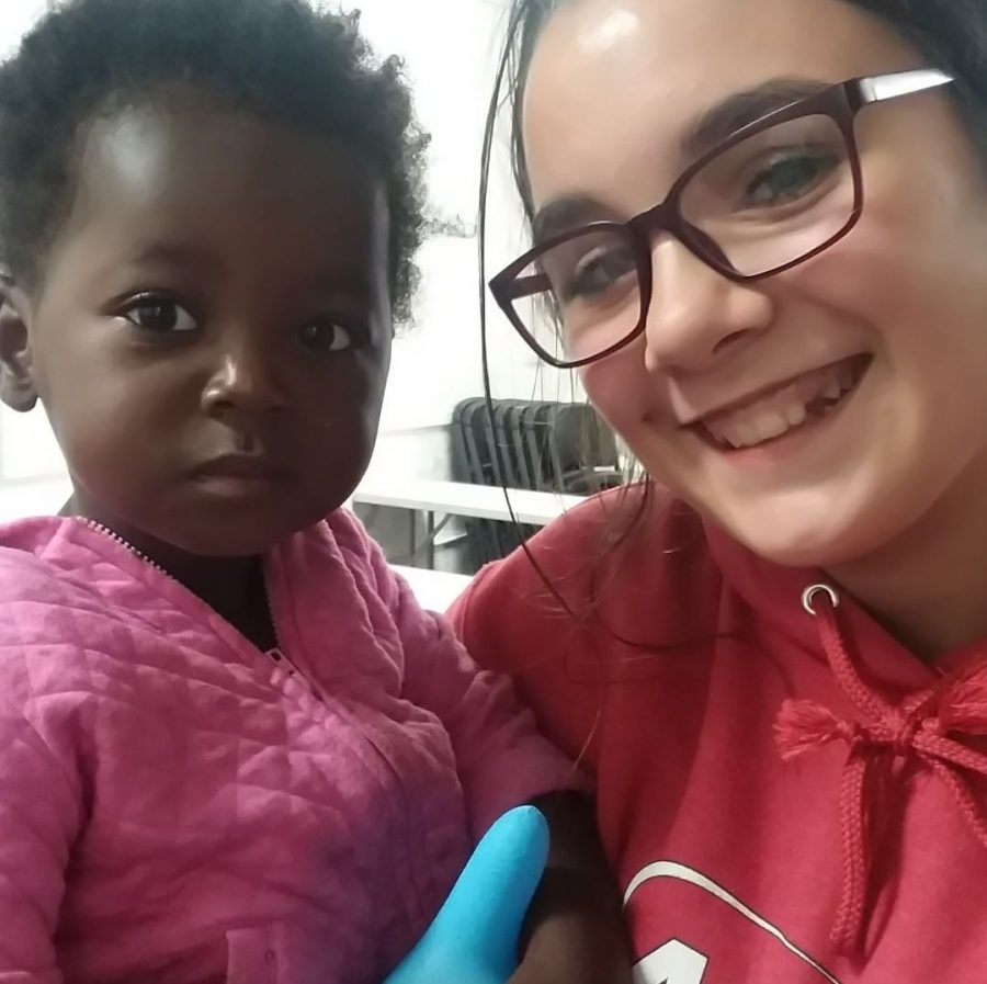 Kaylee Brackett holding a young girl that she 
met at the rescue mission.