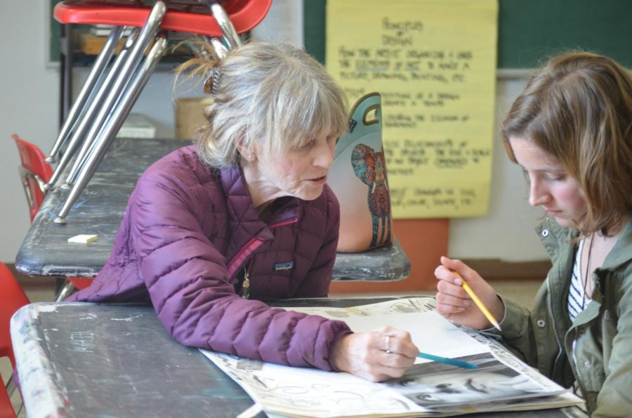 Guthrie gives one of her advanced students assistance on an art project. 
Long time art teacher Heather Guthrie gives pointers to one of her advanced students, senior Chloe Braedt, as she works on a project for the class