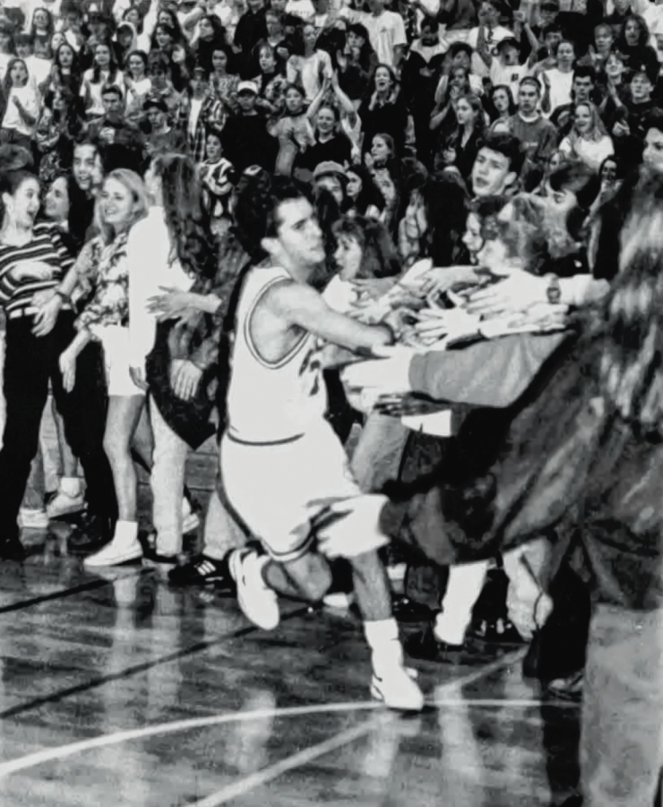 A basketball game during the 1992-93 season appears to be packed with fans.