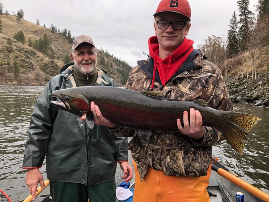 Ethan+Butler+displays+a+Steelhead+on+the+Clearwater+River.