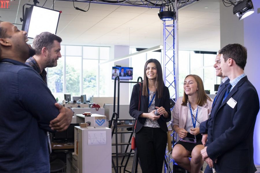 Emi Lynch interacts with USA Today staff during a tour of the USA Today headquarters.