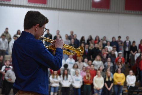Senior Nate Couch plays “Taps” in front of an attentive crowd.