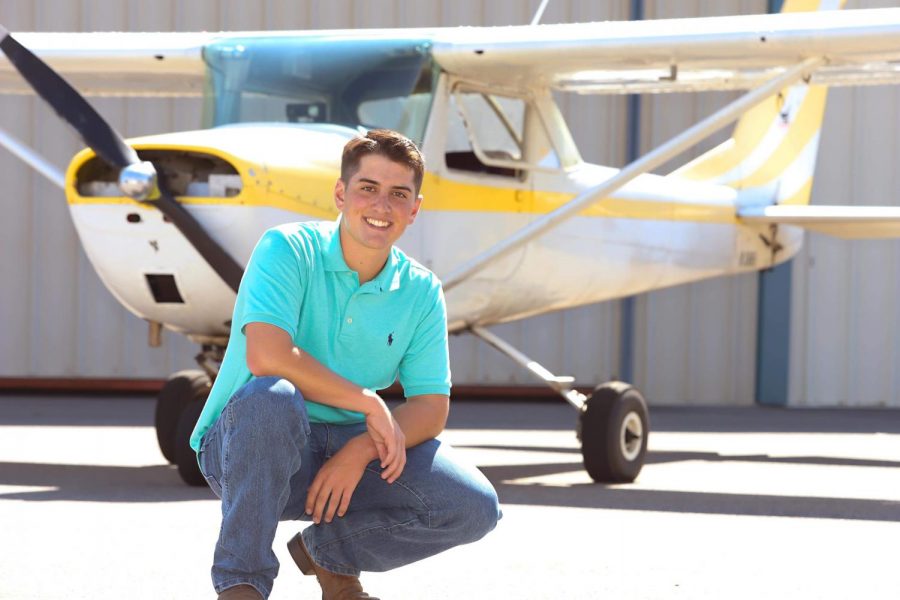 Senior pilot Brody Ponsness poses in front of his plane.